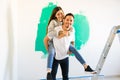 Latin man carrying his partner while doing a home renovation Royalty Free Stock Photo