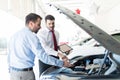 Dealer And Customer Discussing Over Car Engine Royalty Free Stock Photo