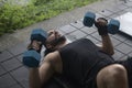 latin man with dumbells int he floor doing bench press Royalty Free Stock Photo