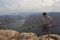 Latin man explorer in the viewpoint El Vigilante and in the background the Zimapan dam in Hidalgo Mexico Royalty Free Stock Photo