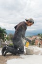 Latin man with his tools making repairs at home. Workman preparing the mixture, painting, repairing and repairing the walls of a h