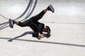 Latin man performing street dance inside skating pit