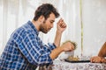 Latin man playing chess board game at home for holiday activity with his family he thinking and look serious Royalty Free Stock Photo