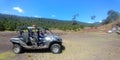 Latin man with protective helmet driving off-road car in forest field outdoors Royalty Free Stock Photo