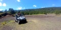 Latin man with protective helmet driving off-road car in forest field outdoors Royalty Free Stock Photo