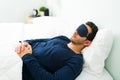 Latin man sleeping with a mask to avoid the light Royalty Free Stock Photo