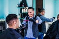 Latin man stylist cutting hair to a client in a barber shop in Mexico Royalty Free Stock Photo