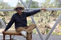 Latin man tourist with hat inside glamping room in mexico desert and drinking lemonade