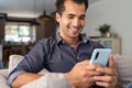 Latin man using smartphone at home Royalty Free Stock Photo