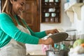 Latin mature woman cooking in old vintage kitchen - Mother preparing lunch at home Royalty Free Stock Photo