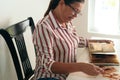 Latin Mature woman looking at a photo album sitting in her home