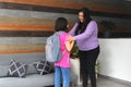 Latin mom with her 10 year old daughter prepare to go back to school with backpack vacations end Royalty Free Stock Photo