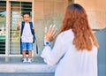 Latin mother saying good bye her student son at school