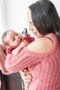 Latin mother smiling holding her baby in her arms looking at her with love Royalty Free Stock Photo