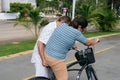 Latin Older man helping his wife to ride a bicycle