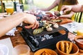 Latin people eating Mexican food, Tacos, spicy salsa, tortillas, beer, snacks and peoples hands over wood table in a restaurant Royalty Free Stock Photo