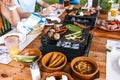 Latin people eating Mexican food, Tacos, spicy salsa, tortillas, beer, snacks and peoples hands over wood table in a restaurant Royalty Free Stock Photo