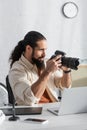 latin photographer taking picture on digital