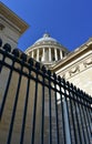 The Pantheon Dome, perspective from below with black iron fence and blue sky. Paris, France. Royalty Free Stock Photo