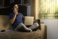 Latin talking on the phone while working at his residentia. Work at home concept Royalty Free Stock Photo