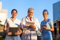 Latin team of medical doctors are looking at camera and smiling while standing outside of mexican hospital in Mexico city or latin Royalty Free Stock Photo