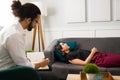 Side view of a woman lying on the couch at therapy Royalty Free Stock Photo