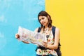 Latin Tourist Woman traveling in Mexico with map and camera on hand. Mexican Girl on backpacking vacation