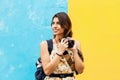 Latin Tourist Woman traveling in Mexico with map and camera on hand. Mexican Girl on backpacking vacation