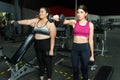 Latin trainer and obese woman using weights Royalty Free Stock Photo