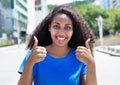 Latin woman with curly hair showing thumbs up Royalty Free Stock Photo