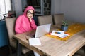 Latin woman in front of her laptop staring at the screen, bored, sleepy, tired in a home office concept in Mexico Latin America Royalty Free Stock Photo