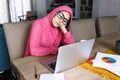 Latin woman in front of her laptop staring at the screen, bored, sleepy, tired in a home office concept in Mexico Latin America Royalty Free Stock Photo