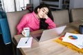 Latin woman in front of her laptop staring at the screen, bored, sleepy, tired in a home office concept in Mexico Latin America Royalty Free Stock Photo