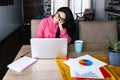 Latin woman in front of her laptop staring at the screen, bored, sleepy, tired in a home office concept in Mexico Latin America Royalty Free Stock Photo