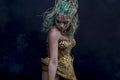 Latin woman with green hair and gold costume with handmade flour Royalty Free Stock Photo
