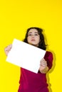 A latin woman holding a white piece of paper in front of her face Royalty Free Stock Photo