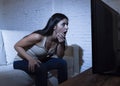 Latin woman home watching television close distance excited in TV addiction concept Royalty Free Stock Photo