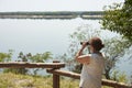 Latin woman looking through binoculars from a viewpoint, El Palmar National Park Royalty Free Stock Photo