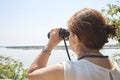 Latin woman looking through binoculars from a viewpoint, El Palmar National Park Royalty Free Stock Photo