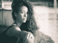 Latin woman looking at camera while touching her hair monochrome