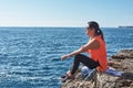 FITNESS LATIN WOMAN IN SPORTS SET TRAINING WITH ELASTIC BAND, WEIGHTS, GYM EXERCISES, IN FRONT OF THE WATER Royalty Free Stock Photo