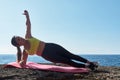 Latin woman, middle-aged, wearing sportswear, training, doing physical exercises, plank, sit-ups, climber`s step, burning calorie Royalty Free Stock Photo