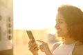 Latin woman paying parking online on phone Royalty Free Stock Photo