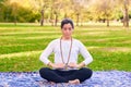 Latin woman performing Reiki poses in a park