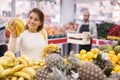 Latin woman in produce section of supermarket