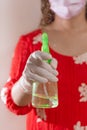 Latin woman with red dress woman taking precautions by covid-19 wear a face mask, gloves and sprayer to prevent infection coronavi Royalty Free Stock Photo