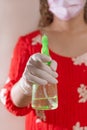 Latin woman with red dress woman taking precautions by covid-19 wear a face mask, gloves and sprayer to prevent infection coronavi Royalty Free Stock Photo