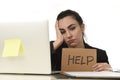 Latin woman showing help sign desperate suffering stress at work while sitting at office laptop Royalty Free Stock Photo