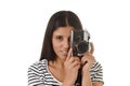 Latin woman taking pictures looking through the viewfinder of an old cool retro vintage photo camera Royalty Free Stock Photo