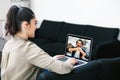 Latin woman talking to her mexican colleagues in video conference business team using laptop Royalty Free Stock Photo